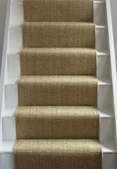 a carpeted staircase leading up to the second floor