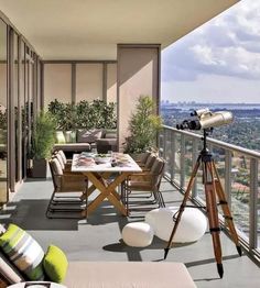 a balcony with furniture and a telescope on the table