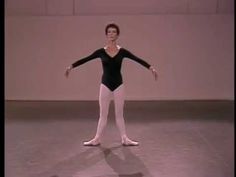 a woman in a black leotard and white tights is standing on one leg