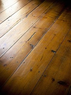 an old wooden floor with no one on it or someone in the room looking at them