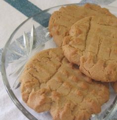 three peanut butter cookies on a glass plate