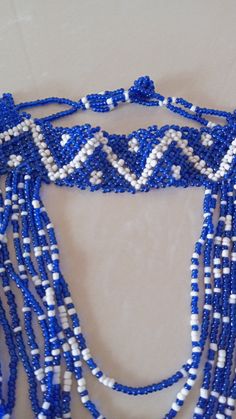 Blue and White Necklace, African Beaded Necklace, African Jewelry, Necklace for Women, Tribal Necklace, Gift For her This beaded necklace is superbly crafted which can be worn with any outfit at different occasions. Main color - Blue and white. The necklace can be available in different colors. Wholesale available at a fair price,please contact me. For any clarification,please send me a convo or an e-mail. Thank you for visiting and happy shopping!!.. Traditional Blue Beaded Choker, Traditional Blue Beaded Choker Necklace, Adjustable Blue Beaded Necklace With Dangling Beads, Blue Beaded Choker With Faceted Beads, Adjustable Blue Dangling Beads, Blue Faceted Beads Choker Necklace, Blue Beaded Choker With Round Beads, Bohemian Blue Choker With Large Beads, Blue Choker With Large Round Beads