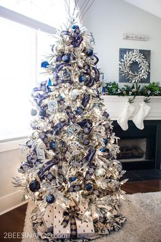 a christmas tree decorated with blue and silver ornaments