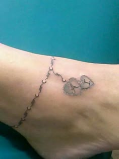 a person with a tattoo on their foot that has an elephant and hearts drawn on it