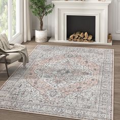 a living room with a fireplace, chair and rug