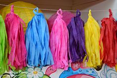 colorful tassels are hanging on a line