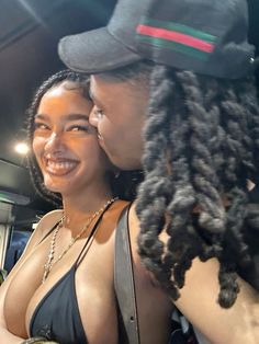 two women with dreadlocks are smiling at each other