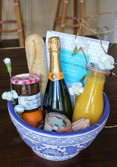 a blue and white bowl filled with food and condiments on top of a wooden table