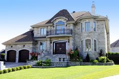 a large house with lots of windows and landscaping