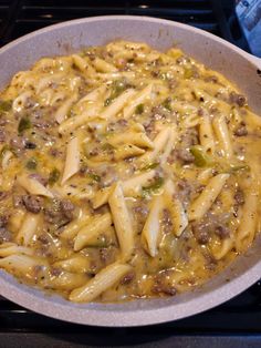 a skillet filled with pasta and sausage