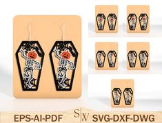 the earrings are designed to look like they have been decorated with flowers and skulls on them