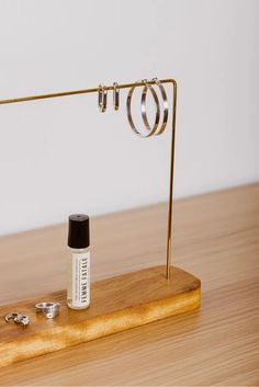 a wooden table topped with a metal ring holder