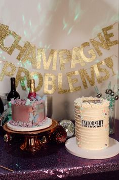 there is a cake on the table with champagne and wine bottles in front of it