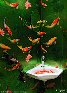 there is a sink with goldfish on it in this bathroom wallpapered area