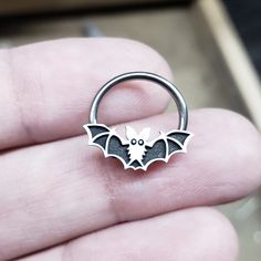 IMPORTANT (size & measuring guide): https://metallotus.com/blogs/body-jewelry/how-to-measure-your-piercing This 16 gauge niobium captive bead ring features a silver bat captive bead design that measures approximately 14.5mm (wide) x 6mm (tall). It works well for septum, conch, helix and daith piercings. * The bat bead design will take up approximately 3mm of the inner diameter when worn as septum or daith jewelry. * Each bead is carefully antiqued and then given a hand-brushed finish to high Silver Body Jewelry For Halloween, Halloween Silver Body Jewelry Gift, Gothic Handmade Body Jewelry Gift, Handmade Gothic Body Jewelry Gift, Handmade Gothic Body Jewelry As A Gift, Unique Halloween Jewelry, Nickel-free Round Jewelry For Halloween, Nickel Free Round Jewelry For Halloween, Adjustable Silver Body Jewelry For Halloween