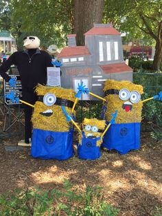 two yellow and blue minion drums sitting in front of a sign