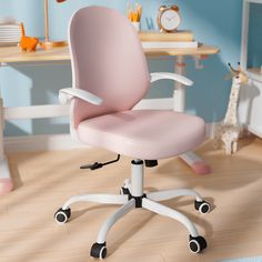 a pink office chair sitting on top of a hard wood floor next to a blue wall