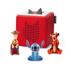 three toy figurines sitting next to a red radio box with the characters from disney's winnie the pooh on it