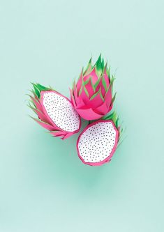 two dragon fruit cut in half on a blue background