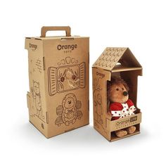 an orange teddy bear in a cardboard box next to it's opened packaging package