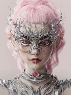 a woman with pink hair and silver jewelry on her face, wearing an elaborate mask