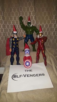 three toy figurines are posed next to a sign that says the elf - avengerss