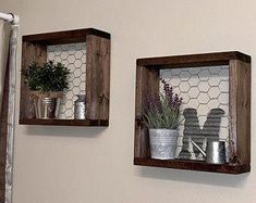 two wooden shelves with pots and pans on them in the corner of a bathroom