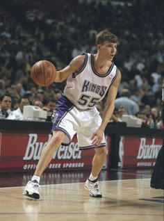 a basketball player dribbling the ball during a game