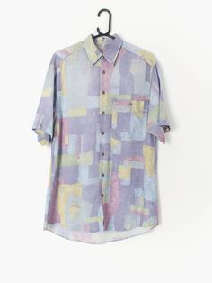 90s Vintage abstract shirt lilac and pastel green, yellow and blue prints with short sleeves Our recommended size: Medium Label Says: 37 / 38 Condition: Very good Material: Feels like viscose Measurements in inches: Pit to pit: 21 Shoulders: 19 Front length: 32 Back length: 33 Sleeve length: 10.5 We've provided garment measurements below and suggest you compare these to a similar garment you own to determine a good fit. Measurements are taken flat and doubled for waist and hip. Information on ho Fitted Multicolor Print Short Sleeve Shirt, Purple Printed Shirt With Short Sleeves, Purple Floral Print Short Sleeve Shirt, Summer Shirt With Abstract Pattern And Short Sleeves, Summer Short Sleeve Shirt With Abstract Pattern, Green Short Sleeve Shirt With Abstract Print, Short Sleeve Tops With Abstract Pattern For Summer, Summer Short Sleeve Tops With Abstract Pattern, Summer Tops With Abstract Pattern And Short Sleeves