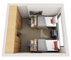 an overhead view of a bedroom with two beds and a desk in the corner next to it