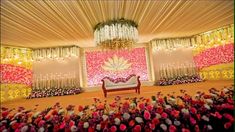 a decorated stage with flowers and chandelier