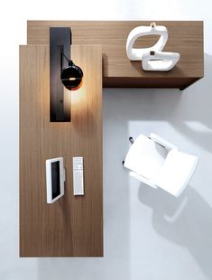 an overhead view of a desk with various items on it, including a lamp and remote control