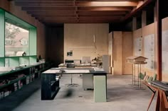 an empty room with tables, chairs and bookshelves in the middle of it