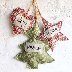 three ornaments hanging on a wall with the words hope, peace and joy written on them