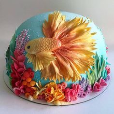 there is a cake decorated with fish and flowers