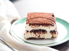 a piece of cake sitting on top of a white and green plate next to a fork