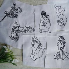 four embroidered napkins with images of women and men on them, one has a flower in front of it