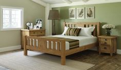 a bed room with a neatly made bed and two night stands