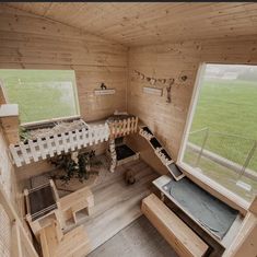 an aerial view of a tiny cabin with wooden walls and flooring, looking down at the loft area