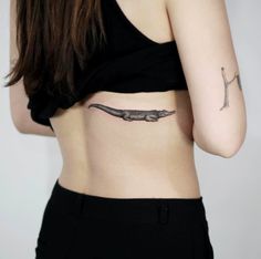 a woman with a tattoo on her stomach and the lower part of her body is shown