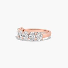 a rose gold ring with three diamonds on it