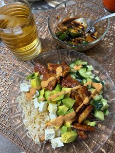 a glass plate filled with food next to a bowl of rice