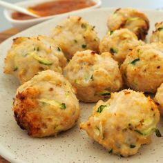 a white plate topped with meatballs covered in cheese