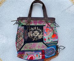 Vintage Boho patchwork bag 1990s with a unique hand embroidery and leather handles . Made in Thailand. Vintage embroidered bag for your colorful summer look. Vintage bags are a trendy accessory that gives style and status to the owner. Condition: very good Hand embroidery leather I collect vintage jewelry and also create unique jewelry from rare materials brought from all over the world. My idea is that you do not have to look for accessories for the image in different places, but you can purcha Multicolor Patchwork Tote Satchel, Festival Patchwork Tote Bag, Bohemian Hobo Bag With Patchwork For Everyday Use, Bohemian Patchwork Hobo Bag For Everyday Use, Bohemian Patchwork Hobo Tote Bag, Bohemian Patchwork Shoulder Bag, Bohemian Square Patchwork Bag, Bohemian Square Shoulder Bag With Patchwork, Traditional Patchwork Shoulder Bag For Everyday