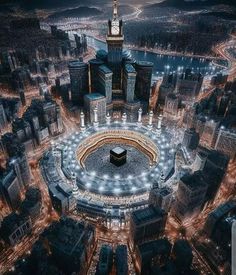 an aerial view of a large stadium in the middle of a big city at night