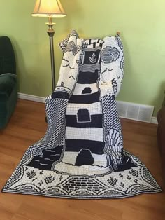 a blanket is laying on the floor in front of a chair and lampshade