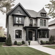 a large gray and white house with black trim