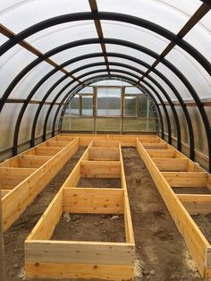 the inside of a large greenhouse with lots of wood