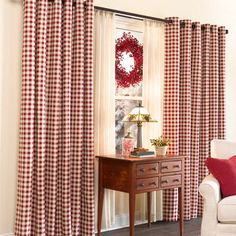 red and white checkered curtains hanging in front of a window with a wreath on it