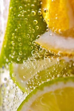 limes and lemon slices with water droplets on them - stock photo - photoshop